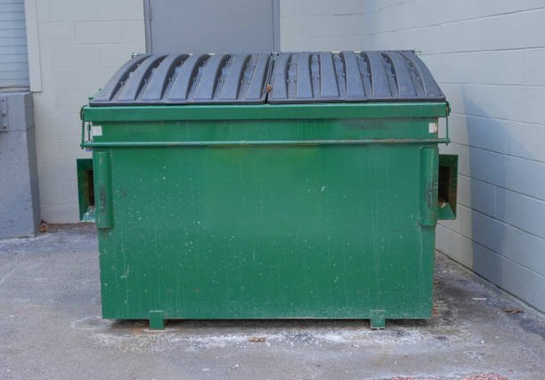 large green commercial dumpster for trash and recycling